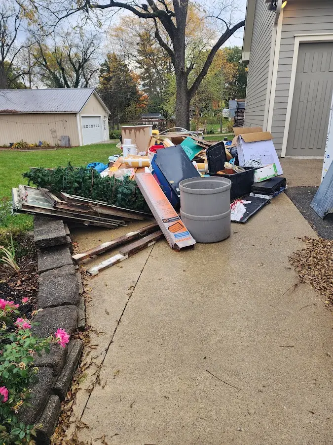 Dumpster being loaded with debris for 12 Yard Dumpster Rental in Myrtletown
